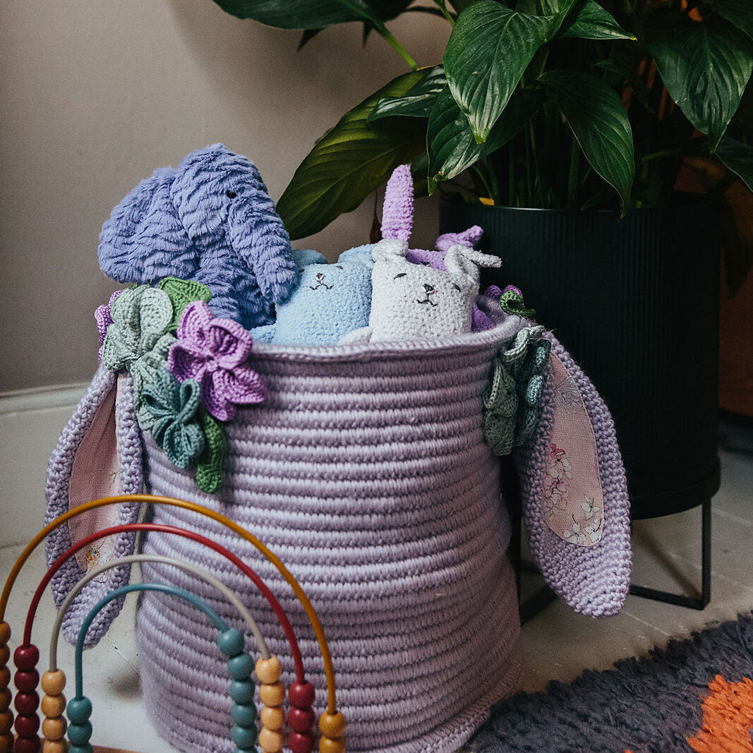 Crocheted toy basket with bunny ears and flowers